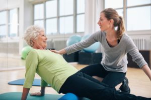 Physical Therapist Working With A Senior Woman At Rehabilitation after surgery